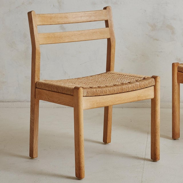 Sold and priced individually. A Danish wood and woven papercord dining chair designed by Kurt Østervig in the 1960s. These...
