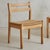 Sold and priced individually. A Danish wood and woven papercord dining chair designed by Kurt Østervig in the 1960s. These...