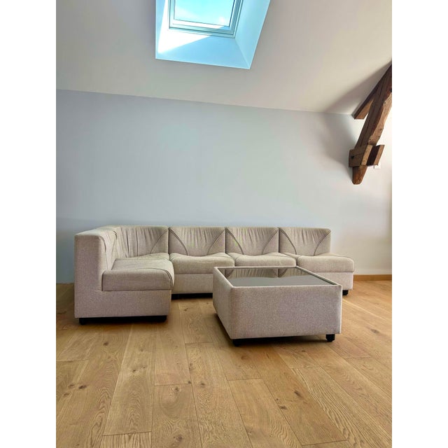 Modular living room composed of five armchairs, including a corner one, as well as a coffee table with a glass top. Wool...