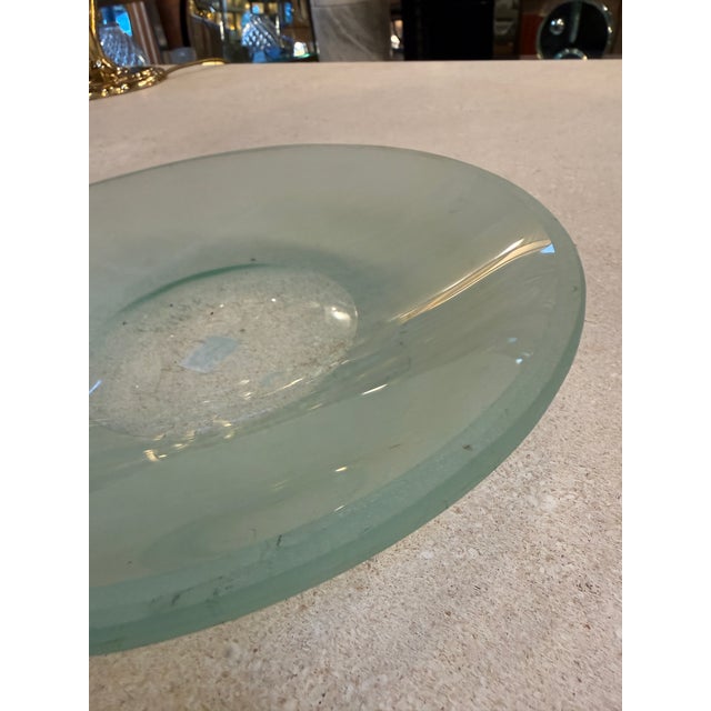 Large Italian Murano glass centerpiece bowl from the 1970s, distinguished by its generous shallow form and subtle green...