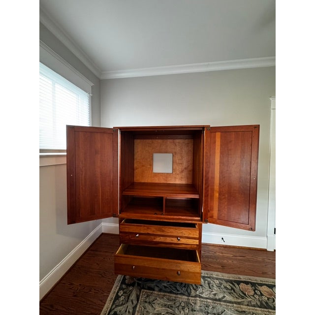 Beautifully crafted solid cherry armoire and entertainment cabinet by the renowned American heritage maker, Nichols &...