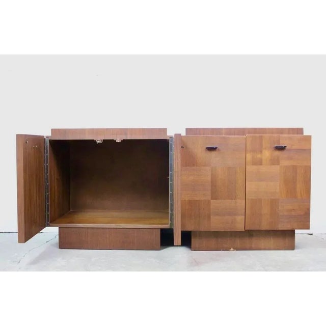 Sleek two-door nightstands with veneered walnut fronts and panels in alternating grain. They have an attractive, Brutalist...