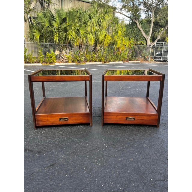 Mid-century modern side tables with smoked inset glass. In the style of John Keal for Saltman Brown. A sleek pair with a...
