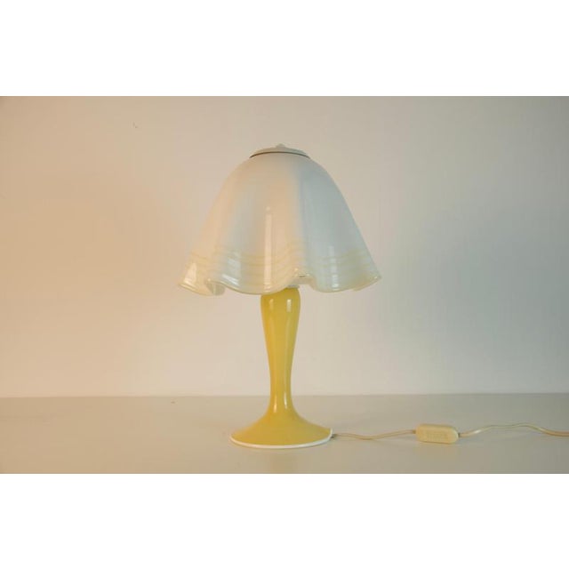 Charming mushroom-shaped table lamp from germany, dating to the 1970s. The lamp features a sculptural yellow glass base...