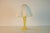 Charming mushroom-shaped table lamp from germany, dating to the 1970s. The lamp features a sculptural yellow glass base...