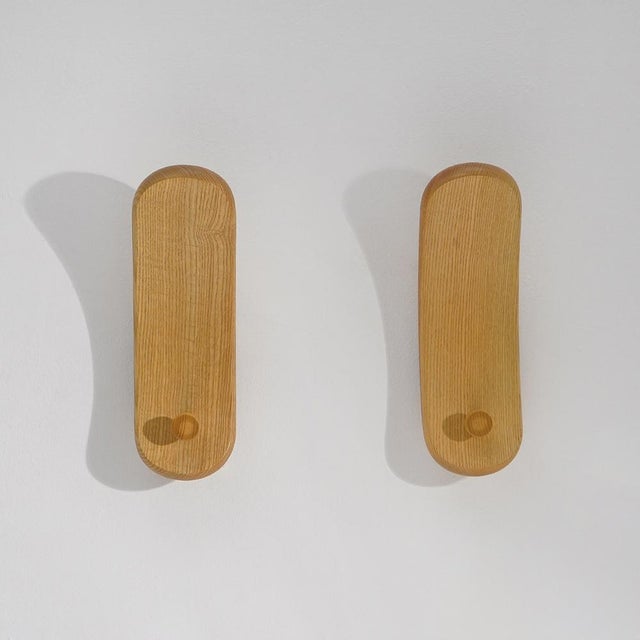 A pair of spatola wall coat hooks designed by de pas, d'urbino and lomazzi for fiarm in the 1970s, conceived to transform...