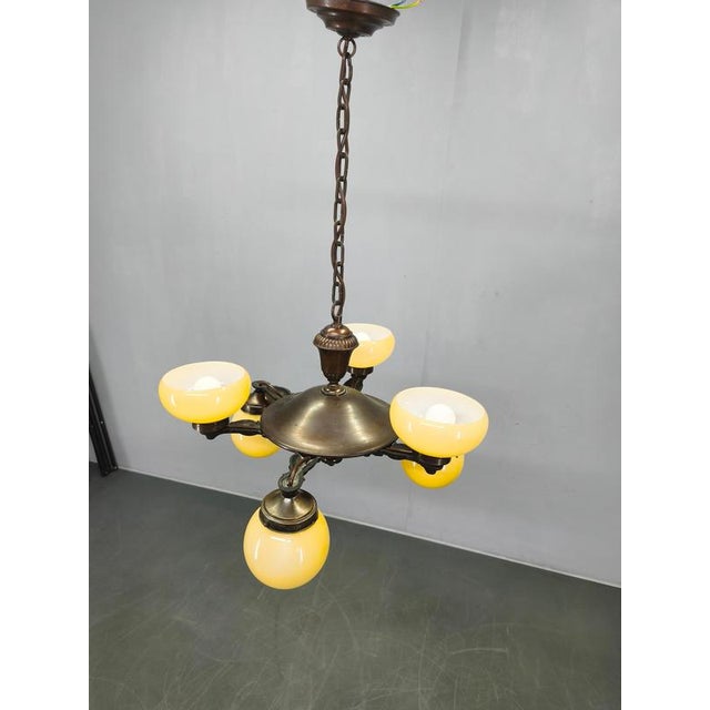 Authentic art deco chandelier produced in czechoslovakia during the 1920s. This refined fixture features a solid brass...