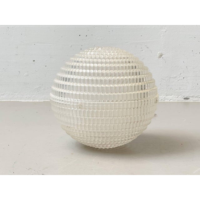 An exceptional and rare pendant lamp with a spherical shade made of translucent plexiglas featuring a striking bubble...