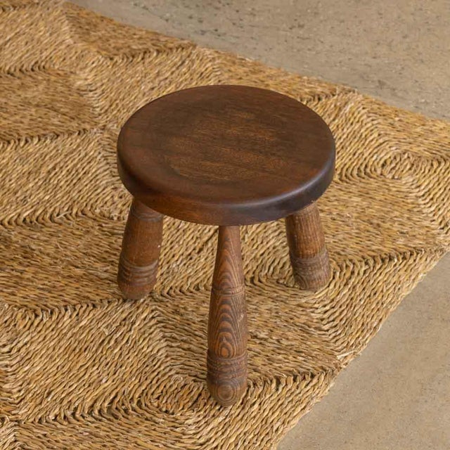 Vintage short wood stool with beautiful carved wood legs and circular seat from France. Original wood finish with great...