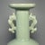 This elegant vessel is a classic Longquan celadon vase from China, decorated with a pair of vivid carp-shaped handles on...