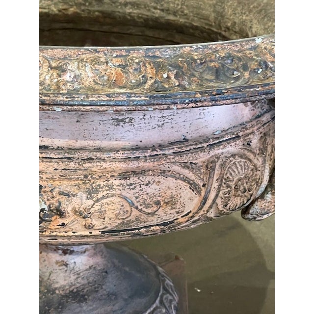 This 19th century French iron planter is a decorative collectible that adds a touch of elegance to any space. Crafted with...