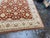 Design Plus Gallery presents a 7ft 11in × 9ft 11 Pak-Veg Hand-Knotted Wool Area Rug. The design showcases a rust-toned...