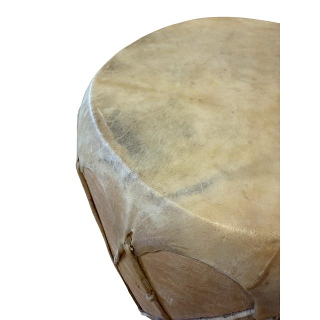 A traditional drum, covered in hide with a rich patina over a wooden frame. Rustic and simplistic, the piece can be used...