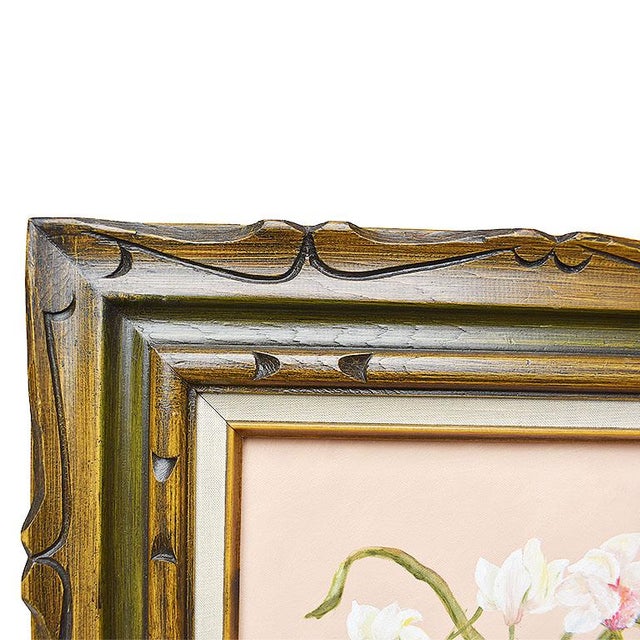 Framed painting of a grouping of orchids. This piece showcases a bouquet of white orchids with light pink stigma. The...