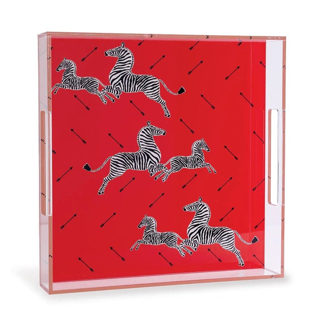 We love the whimsy of the square lucite zebra tray. The Scalamandre zebra pattern in the color of red is your fun serving...