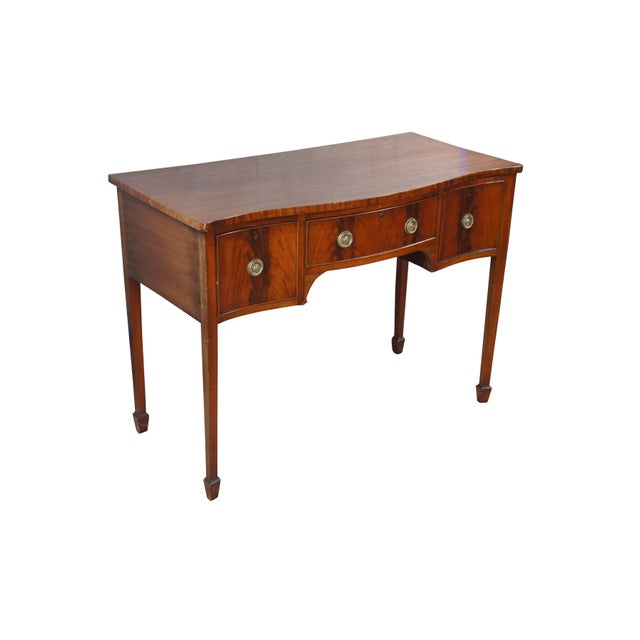 A beautiful antique George III sideboard. Features a mahogany frame with serpentine front over three flame mahogany...