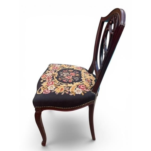 Elegant vintage Hepplewhite-style shield back side chair featuring beautifully preserved original floral needlepoint...