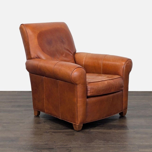 This Ethan Allen lounge chair features rich brown leather with a timeless, classic design. It has supportive rolled arms...