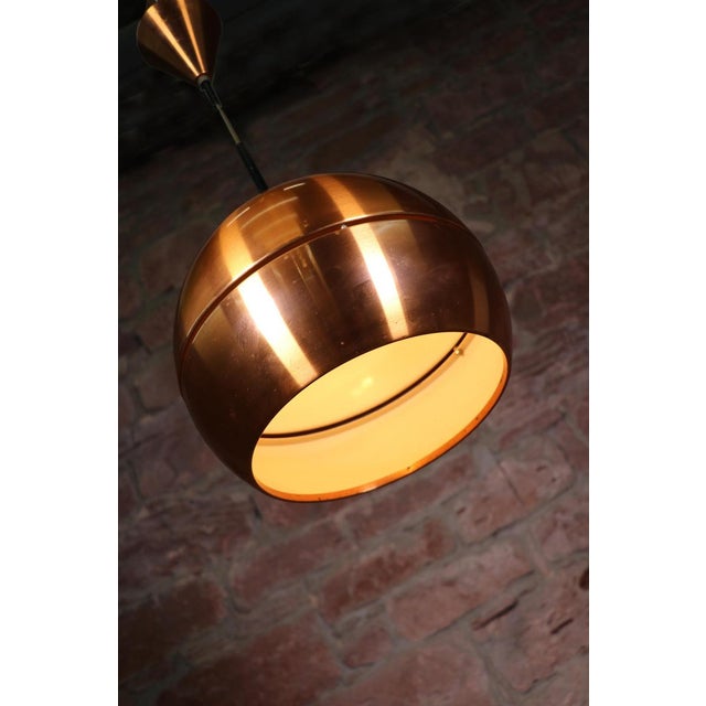 Elegant Danish mid century modern copper pendant lamp on an aluminium frame. Manufactured in Denmark in the 1960s....