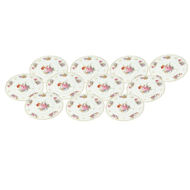 Dine in timeless elegance with our Porcelain Painted and Gilt Floral Bouquet Decorated Set of Eleven Dinner Plates, a...