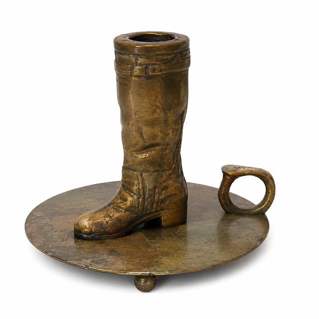 Vintage Ralph Lauren brass chamberstick featuring a sculptural equestrian riding boot mounted on a circular brass tray....