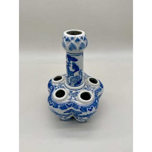 A distinctive 20th-century Chinese blue and white porcelain tulipiere or tulip vase, featuring a central raised spout...