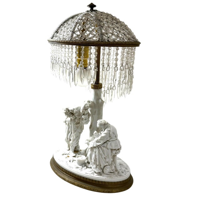 A charming continental figural table lamp, most likely Austrian, dating to circa 1920. The sculptural porcelain...