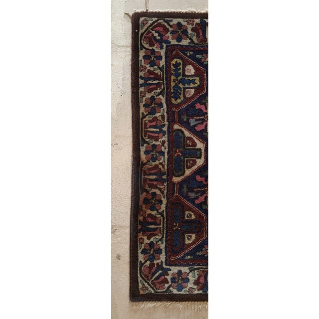 Vintage hand-knotted wool rug featuring a richly patterned geometric and floral design in deep indigo blue, burgundy,...