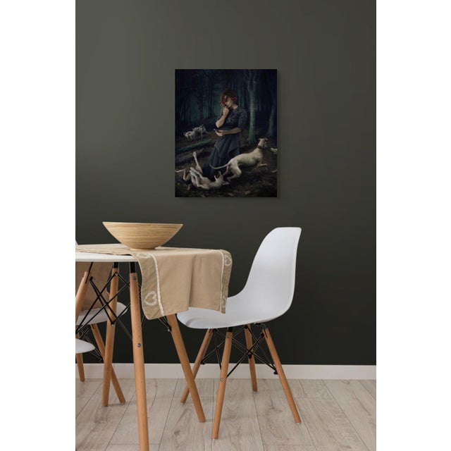 In "Delirium," a figure stands in a shadowy forest, absorbed in a mobile device while surrounded by playful greyhounds....