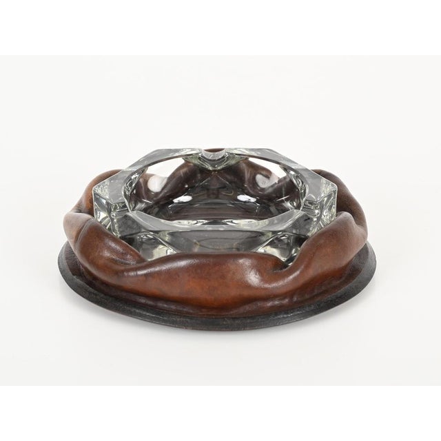 Marvelous mid-century ashtray in curved brown leather and crystal glass. The design of this incredibly stylish ashtray is...