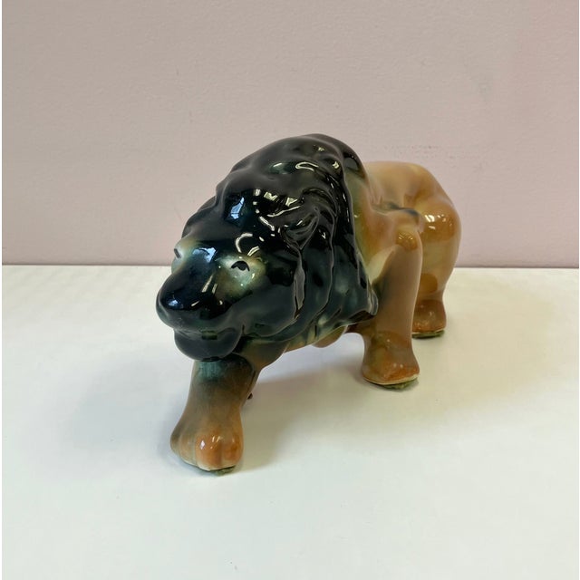 A mid century ceramic stalking lion statue. An impressive piece with wonderful vintage charm. A fabulous statue with a lot...