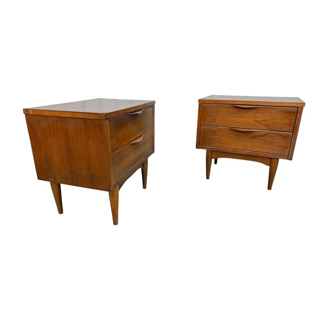 Add timeless Mid-Century Modern style to your bedroom with this handsome pair of walnut nightstands. Featuring clean...
