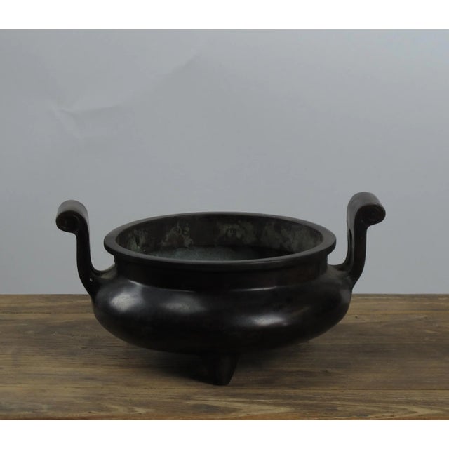 This is a reproduction of traditional Chinese iron incense or oil burner. It is hand forged with two handlers....