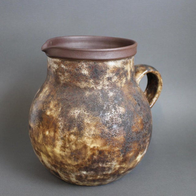 A large ceramic decorative pitcher by alexandre kostanda, vallauris, france (circa 1960s). In his trademark natural clay...