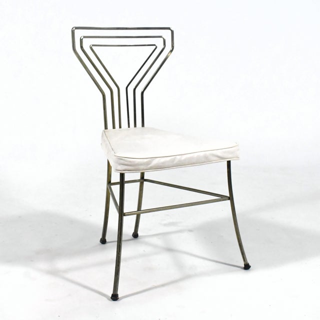 A visually light and lovely design from the 1950s, this side chair has a back with a pattern in bent square stock that...