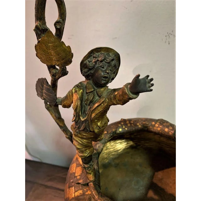 Beautiful bronze basket with boy waving on its edge. The bronze has different patinas of different colors. Modernist...