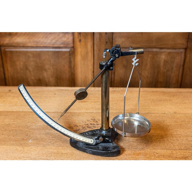 This 20th-century English scale is a captivating piece of industrial design and functional history. Crafted from cast iron...