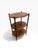 A handsome three-tier accent table featuring a warm brown leather-wrapped surface with decorative embossed borders and...