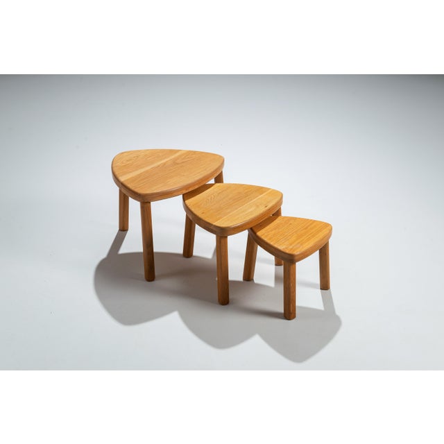 This vintage set of three solid oak nesting tables is a timeless addition to any home, combining practicality with classic...