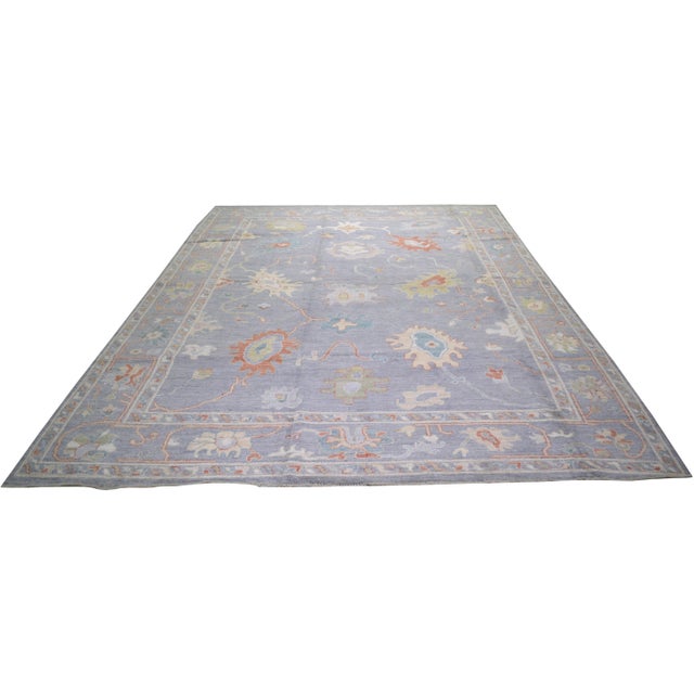 Oushak hand knotted wool rug with fine weave and floral design.