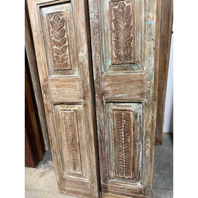 Bring timeless character to your home with these antique blue floral carved pantry doors. Hand-carved from solid wood, the...