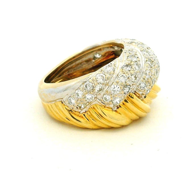 A beautifully sculpted vintage bombe ring by MDJ, crafted in 18K yellow and white gold and designed with the bold glamour...