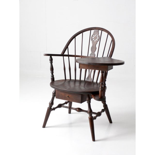 This early 20th-century Windsor writing armchair combines a sweeping bow back with an integrated writing desk and two...