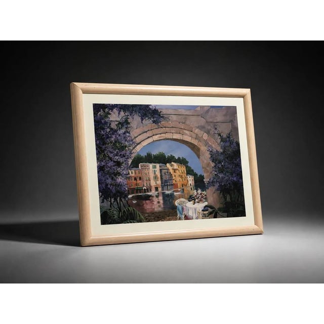Beautiful framed Mediterranean-style waterfront art print featuring an archway view, colorful buildings, water, flowers,...