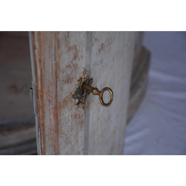 A beautiful Italian demi-lune cabinet with timeless charm. Featuring a hand-painted finish and two doors with a lock for...