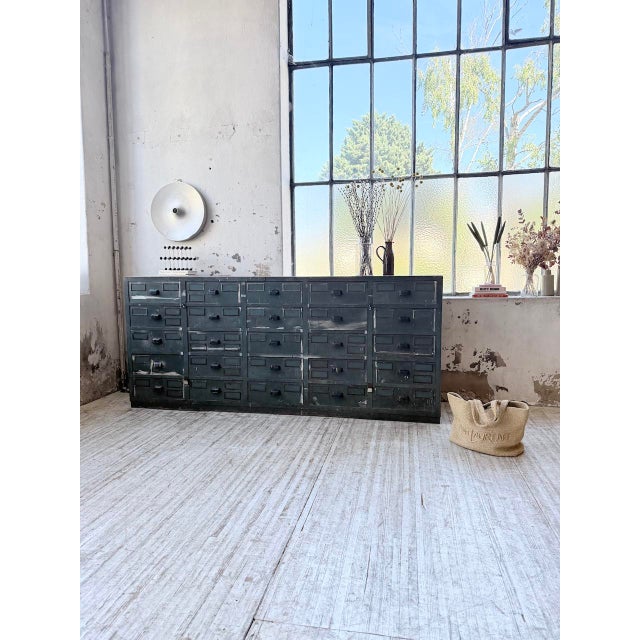 A vintage workshop cabinet with a thick beech top, oak drawer inserts, plywood sides, and pine trim, dating from the...