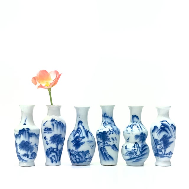 Blue and white bud vases, set of 5. This elegant collection of porcelain bud vases showcases a mix of shapes, each adorned...