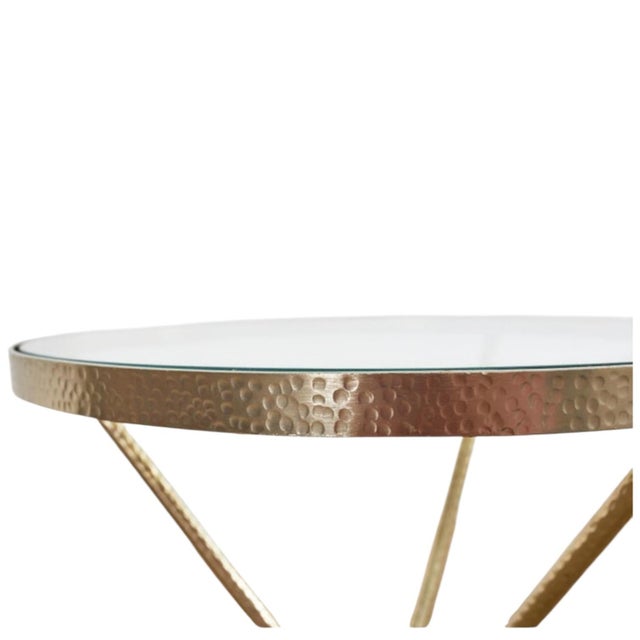 An elegant pair of Midcentury Italian hand-hammered gilded tripod drinks tables captures the essence of refined European...