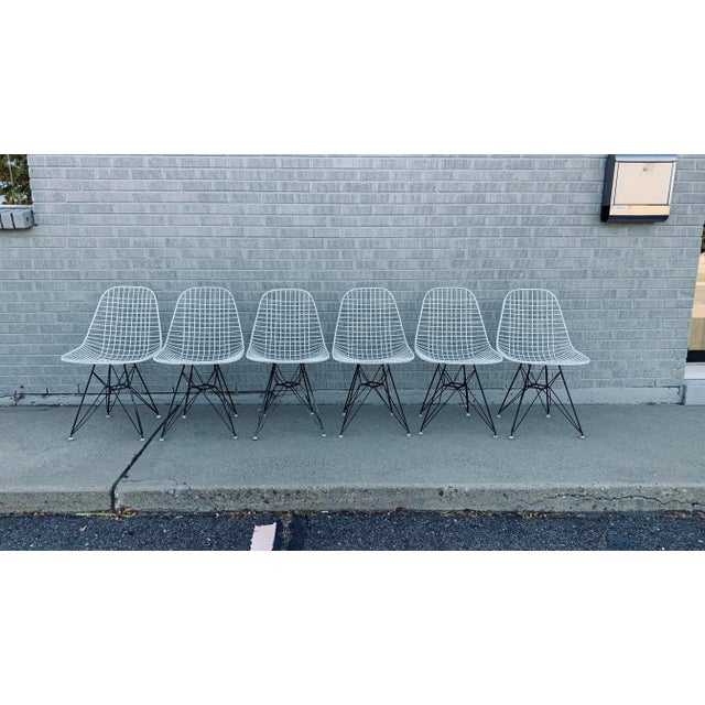 A set of 6 early Original Eames for Herman Miller white wire DKR chairs on black Eiffel tower bases. This classic color...