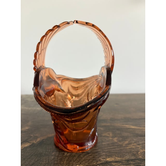 This is a vintage Tiara Indiana Glass "Empress Bird of Paradise" basket in an amber or peach hue, featuring a distinctive...